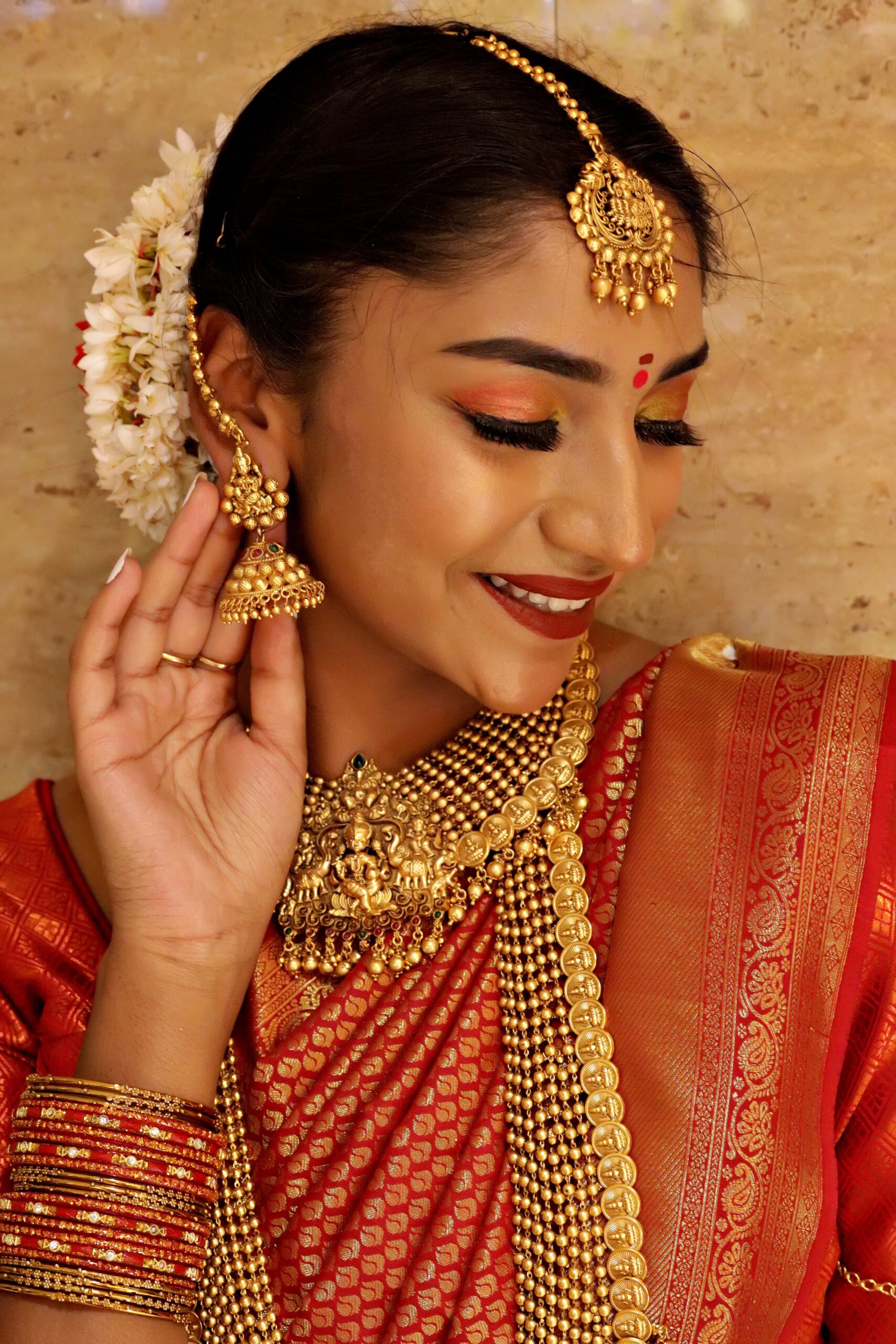 Exquisite portrait of a South Indian bride in traditional attire and jewelry.